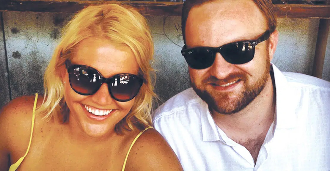 A man and woman pose for a photo wearing sunglasses