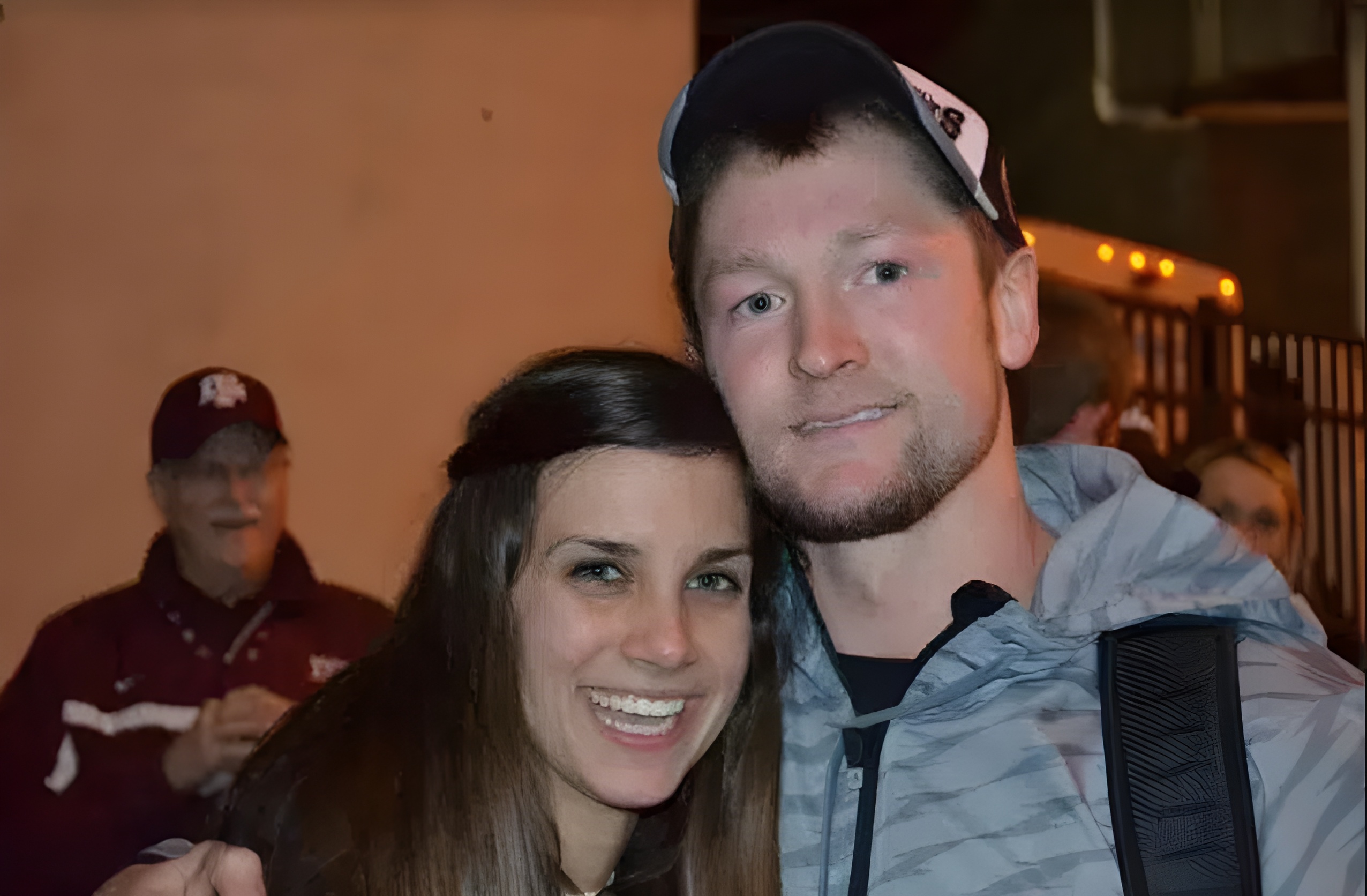 A man and woman smile for a photo