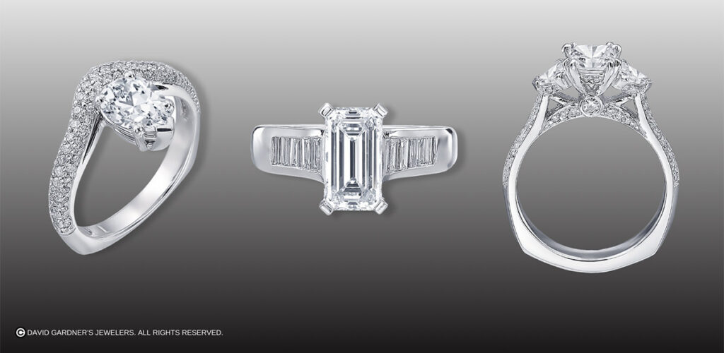Three different styles of white gold diamond engagement rings in a row.