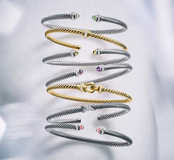 David Yurman cable bracelets in silver and gold.