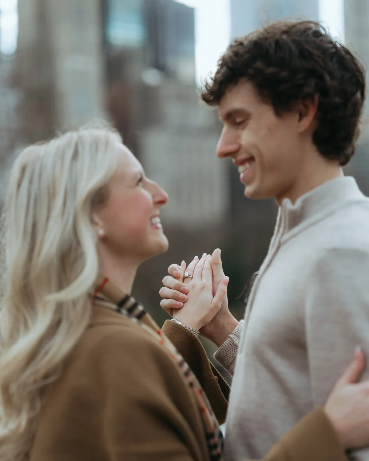 Haley and Jacob smiling with their custom diamond engagement ring by David Gardner's 