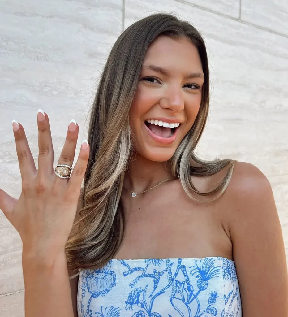 Aggie Graduate smiling with her class ring and RW Fine RingWrap