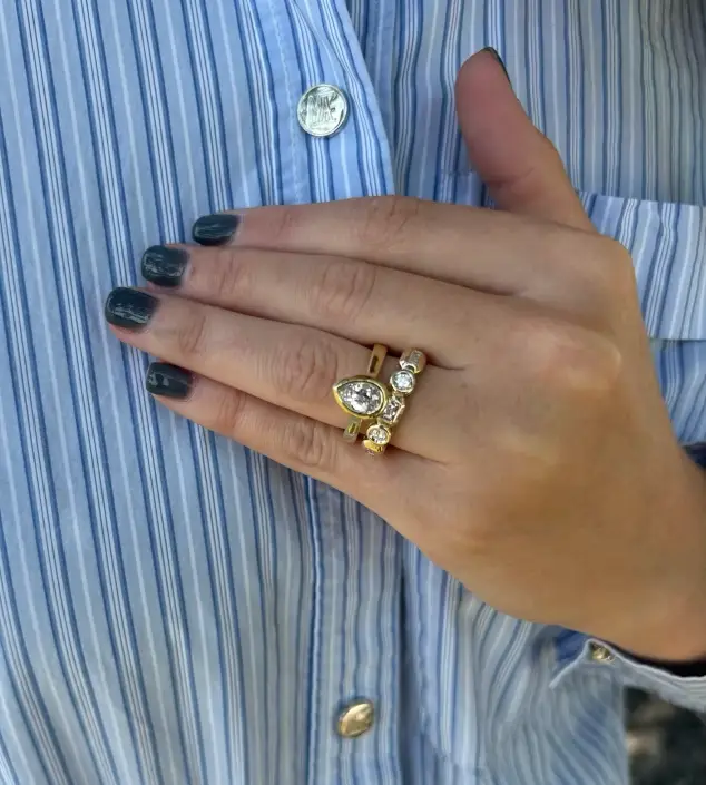 Pear shaped ring on ring finger with wedding band